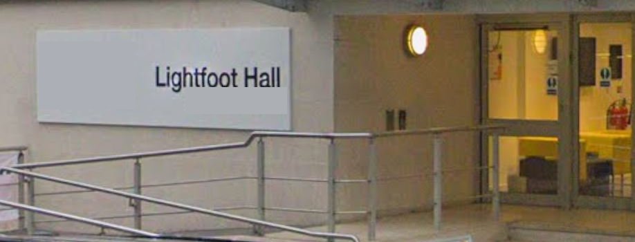 The entrance to Lightfoot Hall on Manresa Road, with the building&rsquo;s name on a sign beside the steps.